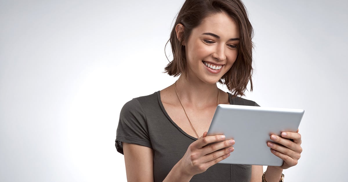 Smiling woman holding tablet